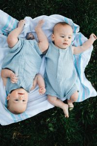 twin babies on a blue blanket