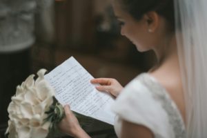 A bride reading a letter from her groom